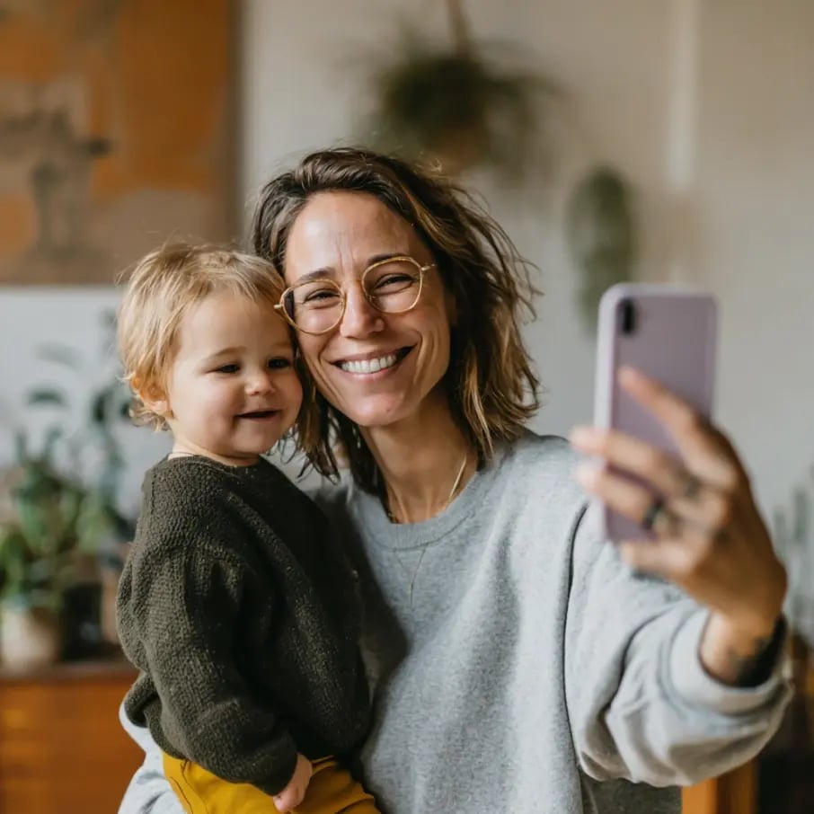 Young mother taking a selfie with her child, photos protected in Tresorit Secure Cloud with end-to-end encryption for private family memories.